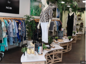 a mannequin and clothing rack at a store